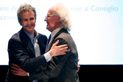 Luciano Benetton, former chairman and founder of Benetton Group SpA, right, hugs his son, Alessandro Benetton, chairman of Benetton Group SpA, at the end of the annual shareholders meeting at the company's headquarters in Ponzano Veneto, near Treviso, Italy, on Tuesday, April 24, 2012. Photographer: Alessia Pierdomenico/Bloomberg *** Local Caption *** Alessandro Benetton, Luciano Benetton