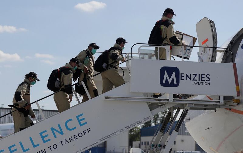 Members of the Czech search and rescue team board a plane at the Vaclav Havel airport in Prague, Czech Republic. AP Photo