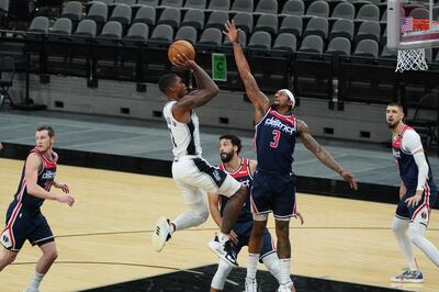 Jan 24, 2021; San Antonio, Texas, USA;  San Antonio Spurs guard Lonnie Walker IV (1) shoots against Washington Wizards guard Bradley Beal (3) in the first half at the AT&T Center. Mandatory Credit: Daniel Dunn-USA TODAY Sports