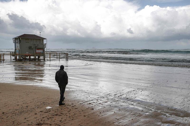 A person stands by the seashore in Israel’s Mediterranean coastal city of Netanya during stormy weather. AFP