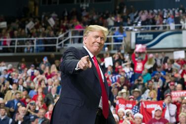 President Donald Trump points to a supporter as he departs a rally at the Mississippi Coast Coliseum in Biloxi. AP/Alex