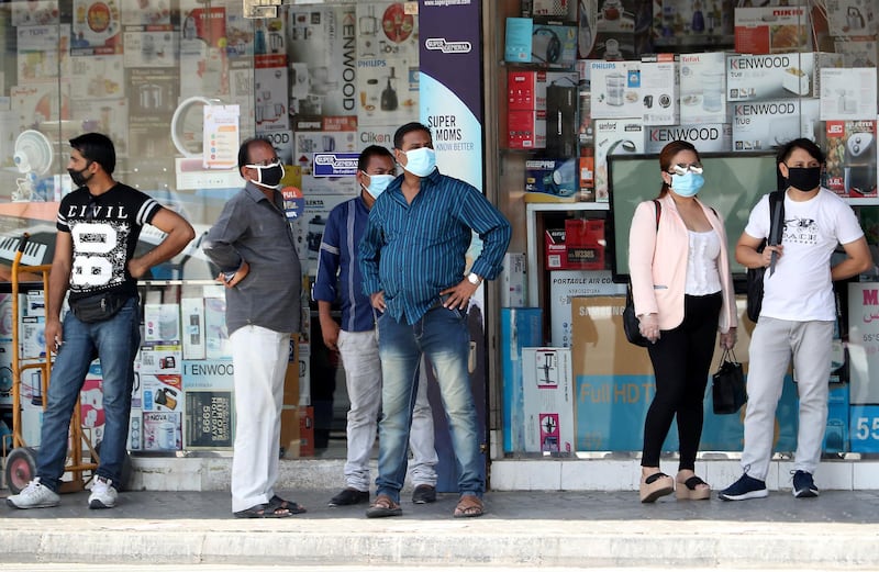 DUBAI, UNITED ARAB EMIRATES , June 11 – 2020 :- People wearing protective face mask during the hot and humid weather and waiting for the bus in Al Satwa area in Dubai. (Pawan Singh / The National) For News/Standalone/Online/Stock