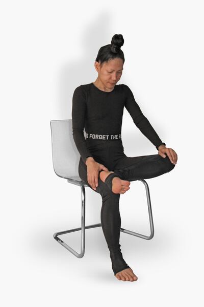The seated figure four will relieve stiffness in the lower back. Courtesy Nerry Toledo