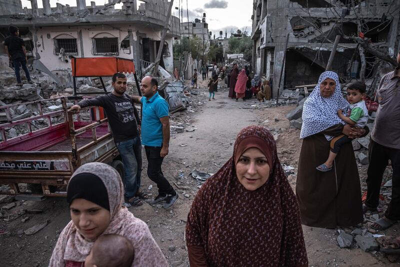 Palestinians walk around Beit Hanoun, northern Gaza, on May 22, 2021. Getty