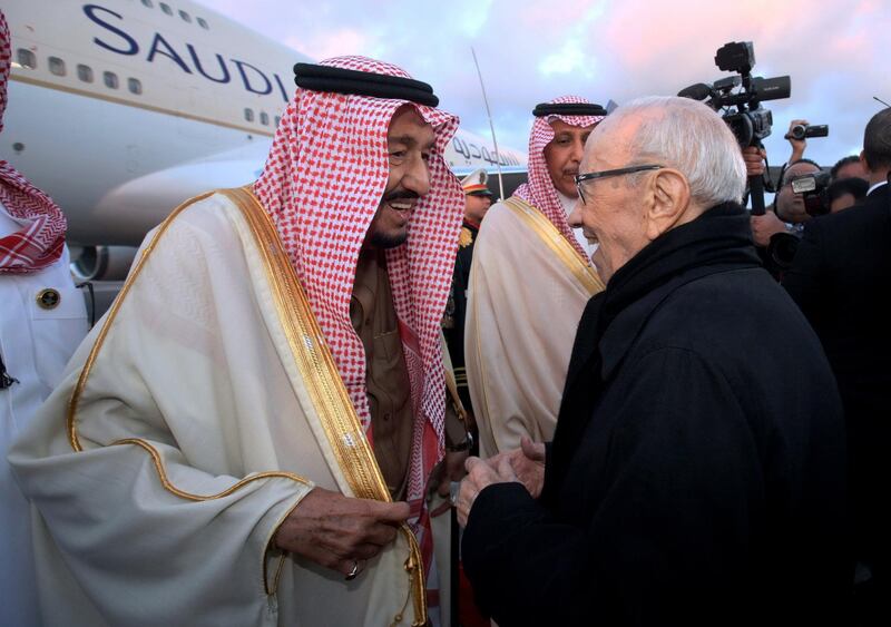 Mr Essebsi, right, greets Saudi Arabia's King Salman at Tunis-Carthage International Airport. AP Photo