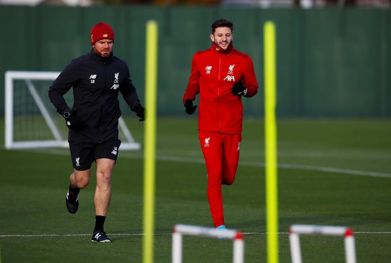 Soccer Football - Champions League - Liverpool Training - Melwood, Liverpool, Britain - December 9, 2019 Liverpool's Adam Lallana with Head Physio Lee Nobes during training Action Images via Reuters/Jason Cairnduff