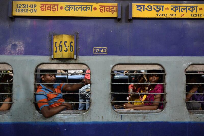 Passengers travel in a non-air conditioner sleeper coach on-board the train.