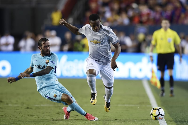 Aleix Vidal (L) of Barcelona and Marcus Rashford of Manchester United fight for the ball during their International Champions Cup (ICC) football match on July 26, 2017 at the FedExField, in Landover, Maryland.  / AFP PHOTO / Brendan Smialowski