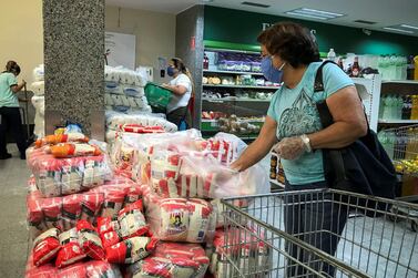 Consumers buy items in a supermarket in Caracas, Venezuela, where the government has announced a price control to three companies producing food to curb inflation. A limited dose of inflation might be welcome to central bankers who have spent trillions of dollars over the years in stimulus to achieve that, say analysts. EPA