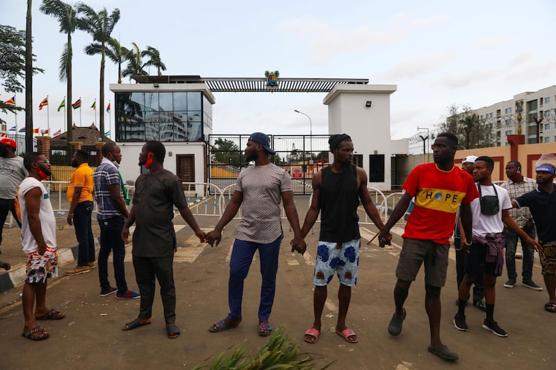 Demonstrators hold hands as they gather near the Lagos State House, despite a round-the-clock curfew imposed by the authorities on the Nigerian state of Lagos in response to protests against alleged police brutality, Nigeria October 20, 2020. REUTERS/Temilade Adelaja