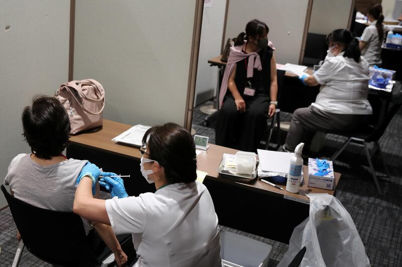 Aeon employees receive the Moderna Covid-19 vaccine at the company's shopping mall in Chiba, Japan. Reuters