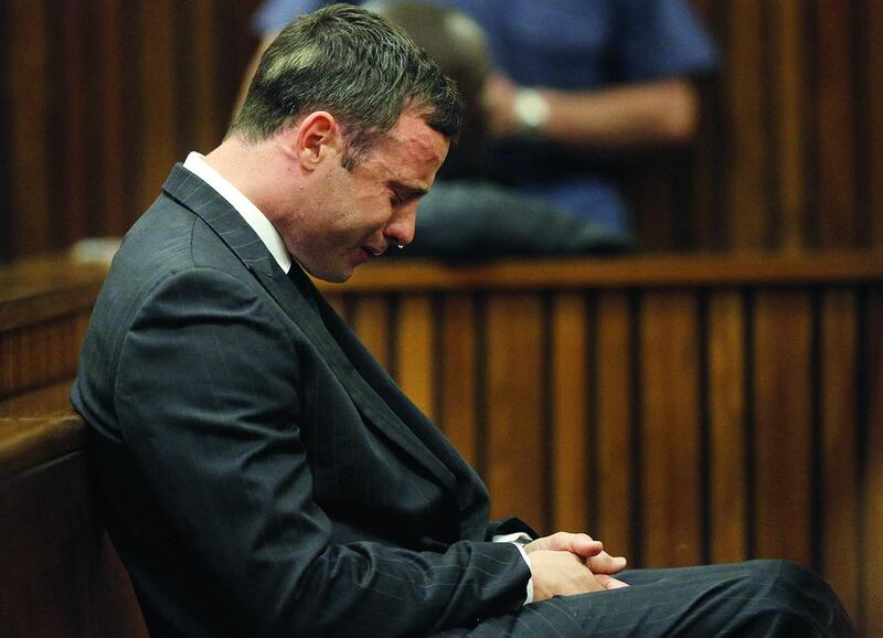 Oscar Pistorius reacts in the Pretoria High Court on September 11 in Pretoria, South Africa. South African Judge Thokosile Masipa had ruled out murder charges but had left it until the next day to announce whether Oscar Pistorius was guilty of culpable homicide as the six-month trial of the Olympic double-amputee sprinter came to an end. His defence maintained that Mr Pistorius mistook Ms Reeva Steenkamp for an intruder in his home when he fired several shots into his bathroom allegedly in self-defence but killing his girlfriend.  Kim Ludbrook / EPA/Gallo Image/Getty Images
