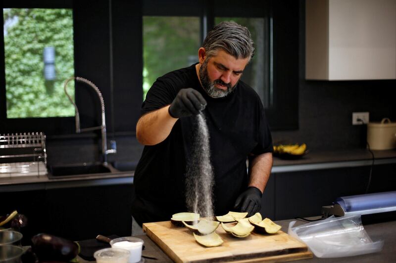 Omar Sartawi, a Jordanian chef, processes aubergine peels to produce a type of leather to make sustainable face masks. Reuters