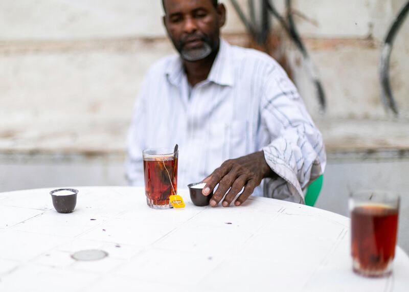 JEDDAH, KINGDOM OF SAUDI ARABIA. 2 OCTOBER 2019. 
Men having some tea in the alleyways of Al Balad, Jeddah’s historical district. The World Heritage Site was founded in the seventh century and was once the beating heart of Jeddah, Saudi Arabia’s second-largest city. The town was formed as an ancient trading port and acted as the primary gateway to Makkah. Today, it is famous for its traditional buildings, which were constructed with coral-stone and decorated with intricate latticed windows.
(Photo: Reem Mohammed/The National)

Reporter:
Section: