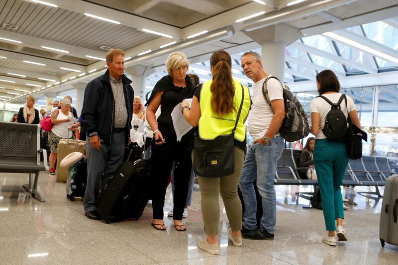 Passengers are seen at Thomas Cook check in points at Mallorca Airport, in Palma de Mallorca, Spain. Reuters