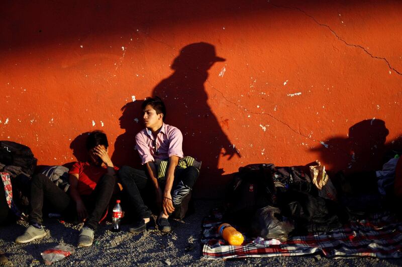Central American migrants, moving in a caravan through Mexico, wait next to a railway line for a freight train, in Irapuato, in Guanajuato state, Mexico. Edgard Garrido / Reuters