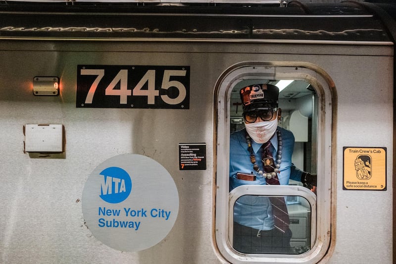 A conductor wears a protective mask while operating a subway train in New York. Bloomberg