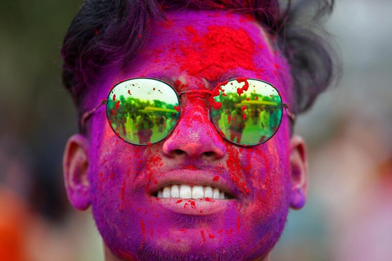 Holi, the popular Hindu spring festival of colours, is observed in India and across countries at the end of the winter season on the last full moon of the lunar month, which is March 8 this year. A student of Rabindra Bharati University daubed in colours looks on during the Holi celebrations inside the university campus in Kolkata, India March 5, 2020. Reuters