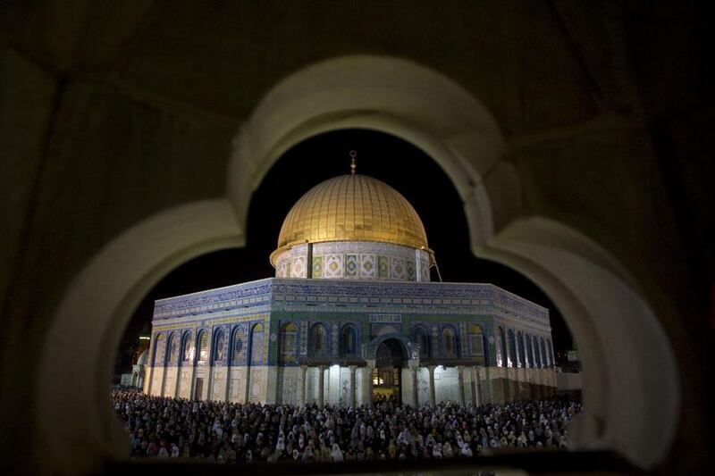 Muslim worshippers pray overnight outside at the Dome of the Rock in the Al-Aqsa mosques compound in Jerusalem's Old City on the occasion of Lailat al-Qadr which falls on the 27th day of the month of Ramadan.  Ahmad Gharabli / AFP Photo