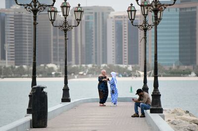 Women spend time by the Corniche, Abu Dhabi. Khushnum Bhandari / The National