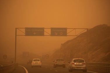 Motorists travel on the TF-1 highway on February 23 after the sandstorm hit Tenerife. Airports on the Canary Islands were closed after strong winds carrying sand from the Sahara shrouded the tourist hot spot. AFP