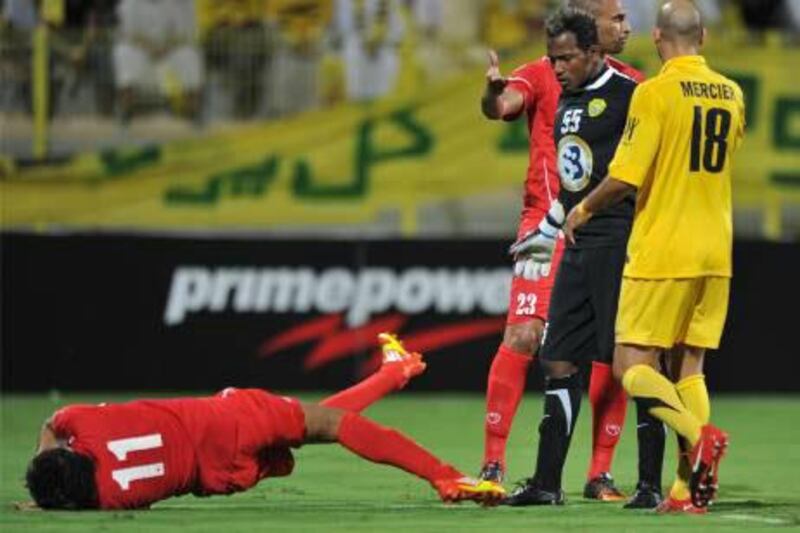 Majed Naser, the Al Wal goalkeeper, stands over Al Muharraq’s Ismail Abdul Latif after butting him, an incident that led to the Emirati being sent off on 10 minutes.