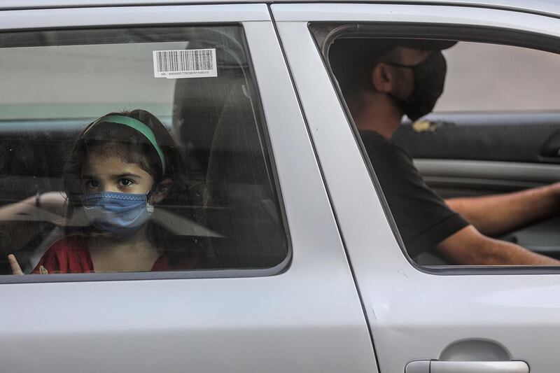 Palestinians wear protective face masks amid the ongoing coronavirus Covid-19 pandemic in Gaza port, Gaza City. EPA