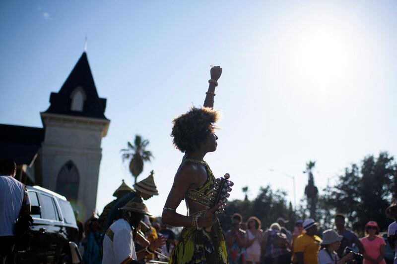 Prescylia Mae, centre, raises her fist in the air during a Juneteenth re-enactment celebration in Galveston, Texas. This was the day in 1865 when the last enslaved African Americans learned that they were free. AFP