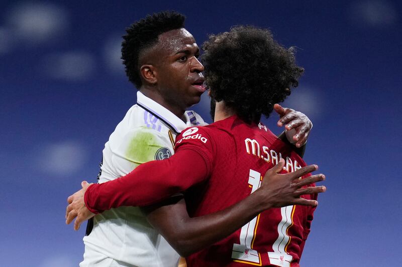 Real's Vinicius and Mohamed Salah embrace. AP