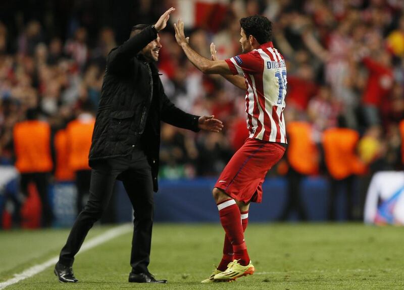 Atletico Madrid striker Diego Costa celebrates with coach Diego Simeone after scoring against Chelsea on Wednesday in the Champions League. Stefan Wermuth / Reuters / April 30, 2014