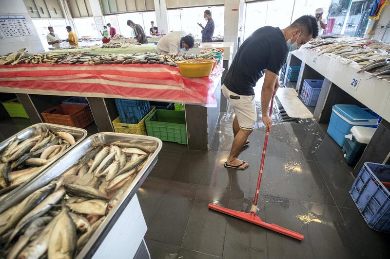 DUBAI, UNITED ARAB EMIRATES. 19 AUGUST 2020.  STANDALONE. Jumeirah Fish Market during the time of COVID-19 measures. Jasson Ramelo (Phil) takes care of his stall in the quiet fish market. “It’s been very slow, but we do see some of the regular customers still coming in.” (Photo: Antonie Robertson/The National) Journalist: STANDALONE Section: National.