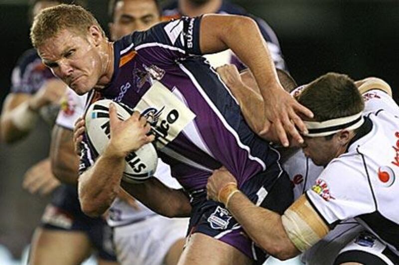 Todd Lowrie of the Storm is tackled during the game against the Warriors in Melbourne.