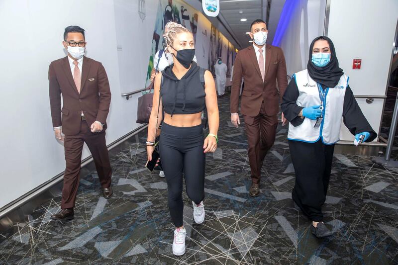 Paige VanZant, accompanied by Etihad staff, arrives in Abu Dhabi from Las Vegas. Etihad Airways