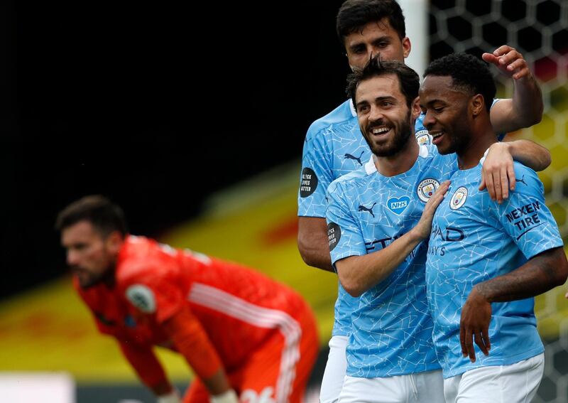 Manchester City's Raheem Sterling, right, celebrates with teammates after scoring his side's second goal. AP