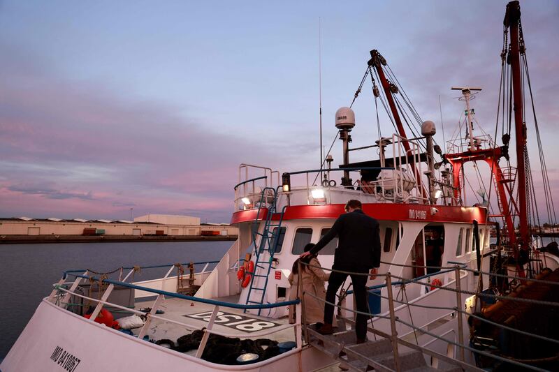 British embassy officials arrive at a British trawler detained in Le Havre, northern France. AFP