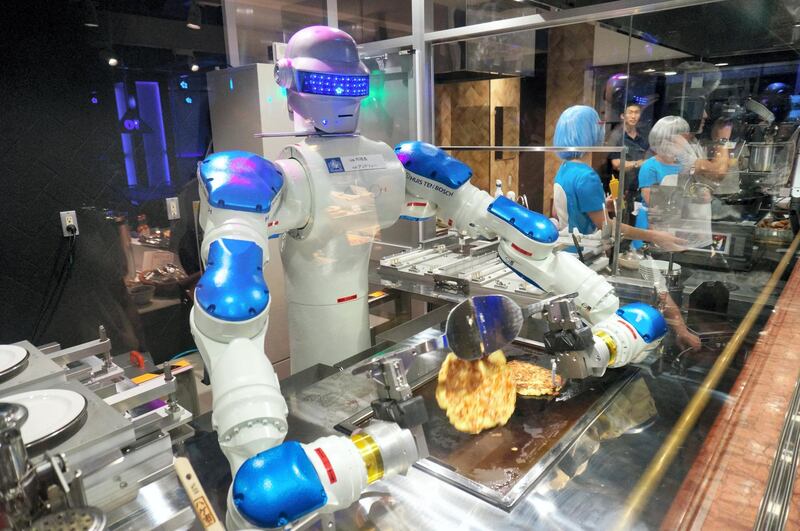 SASEBO, JAPAN - JULY 12:  (CHINA OUT, SOUTH KOREA OUT) Head chef robot 'Andrew' flips the Okonomiyaki, Japanese pancake in the 'Hen na (weird) Restaurant ' during the 'Kingdom of Robot' press preview at the Huis Ten Bosch amusement park on July 12, 2016 in Sasebo, Nagasaki, Japan. The attraction will be opened on July 16.  (Photo by The Asahi Shimbun via Getty Images)