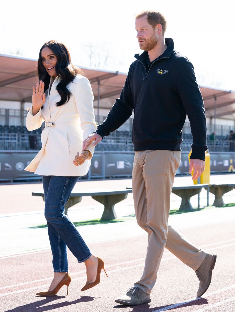 Meghan, joined by the Duke of Sussex, attends the track and field event at the Invictus Games wearing an Ivory belted Brandon Maxwell blazer, jeans and nude suede heels. AP