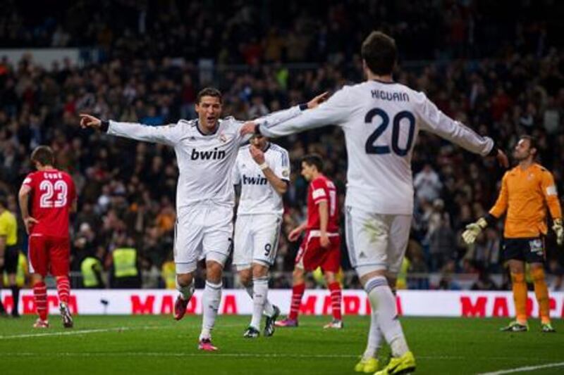 Cristiano Ronaldo celebrates his hat-trick against Sevilla with teammate Gonzalo Higuain.