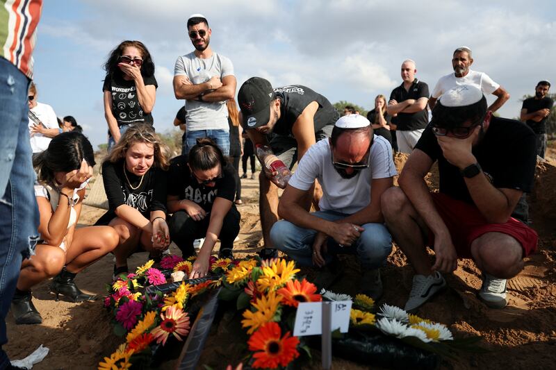 People mourn at the graveside of Eden Guez, who was killed as she attended a festival that was attacked by Hamas gunmen from Gaza that left at least 260 people dead, at her funeral in Ashkelon, in southern Israel, October 10, 2023.  REUTERS / Violeta Santos Moura