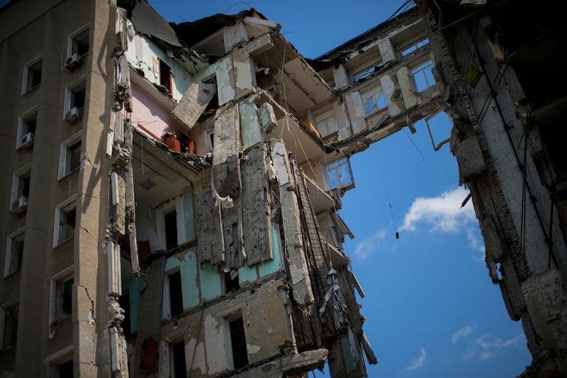 Debris hangs from a regional government building in Mykolaiv, which was heavily damaged in a Russian attack. AP