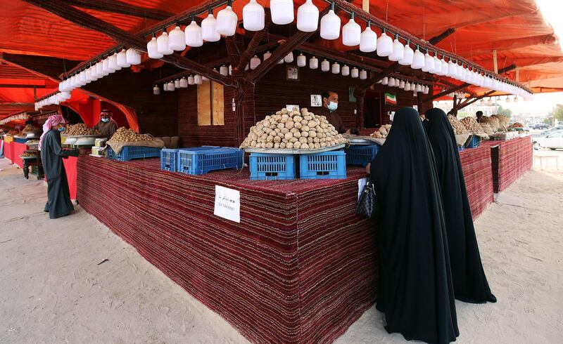 Kuwaiti women buy desert truffles at a market in Kuwait City. AFP