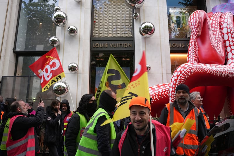 Protesters outside the Louis Vuitton luxury goods boutique. Bloomberg