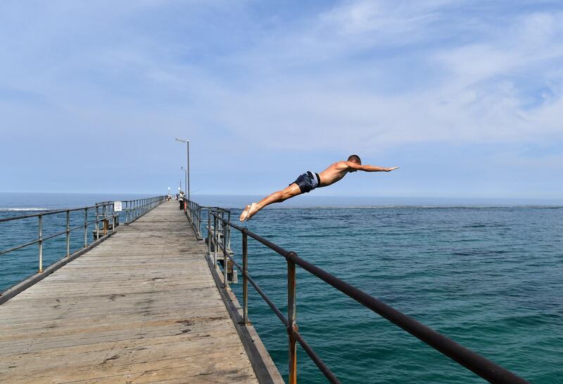 A man jumps from the Port Noarlunga Jetty in the City of Onkaparinga, south of Adelaide, Australia.  EPA