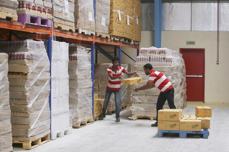 Workers load a palette with boxes of food at the Chilly Willy manufacturing facility.