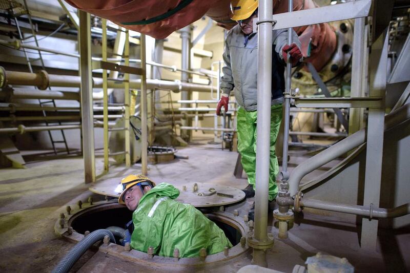 Workers below the decks of an under-construction Maersk triple-E class container ship. Ed Jones / AFP