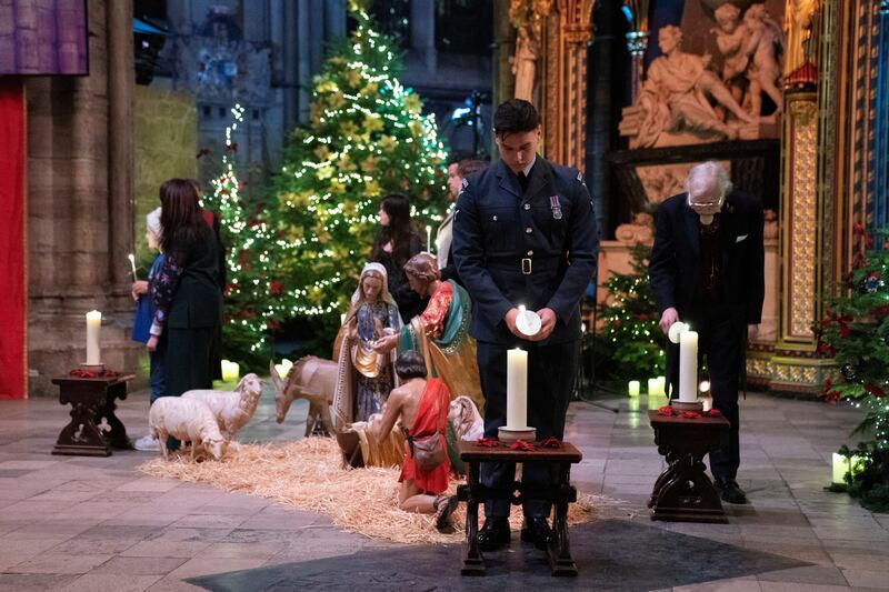 Candles are lit during the carol service at Westminster Abbey. Reuters