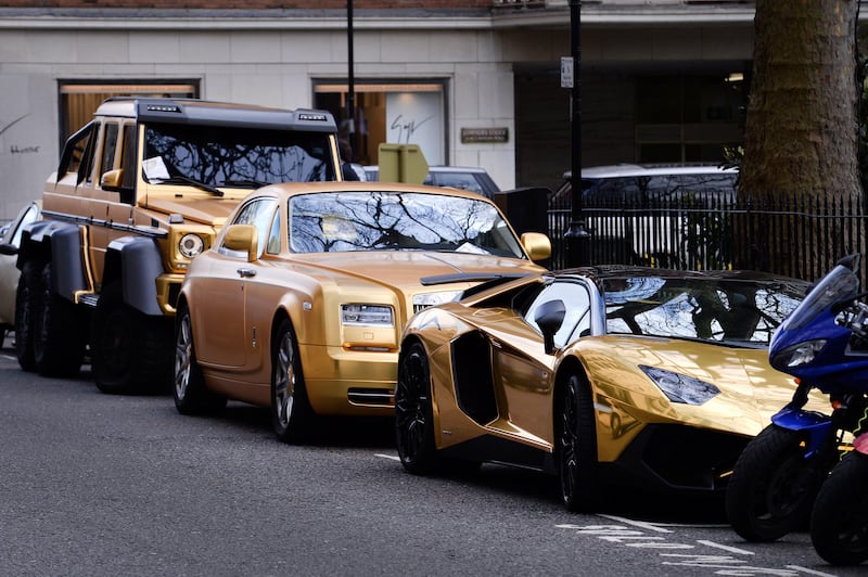 Three gold cars from Saudi Arabia (left-right) a 6x6 Mercedes G 63, Rolls-Royce Phantom Coupe and Lamborghini Aventador have received parking tickets on Cadogan Place in Knightsbridge, London.