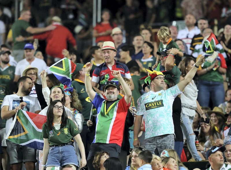 Dubai, United Arab Emirates - December 07, 2019: South Africa fans celebrate during the game between New Zealand and South Africa in the mens final at the HSBC rugby sevens series 2020. Saturday, December 7th, 2019. The Sevens, Dubai. Chris Whiteoak / The National
