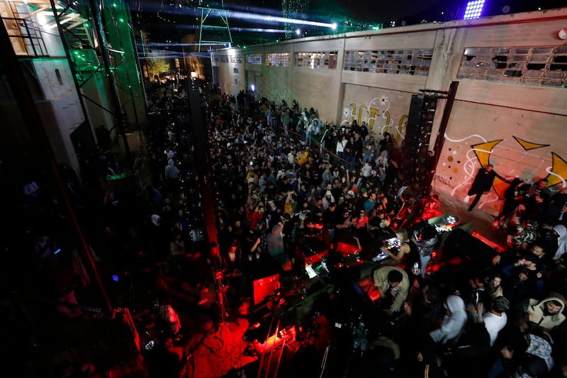 Crowds of music lovers pack the abandoned cement factory to dance the night away. 