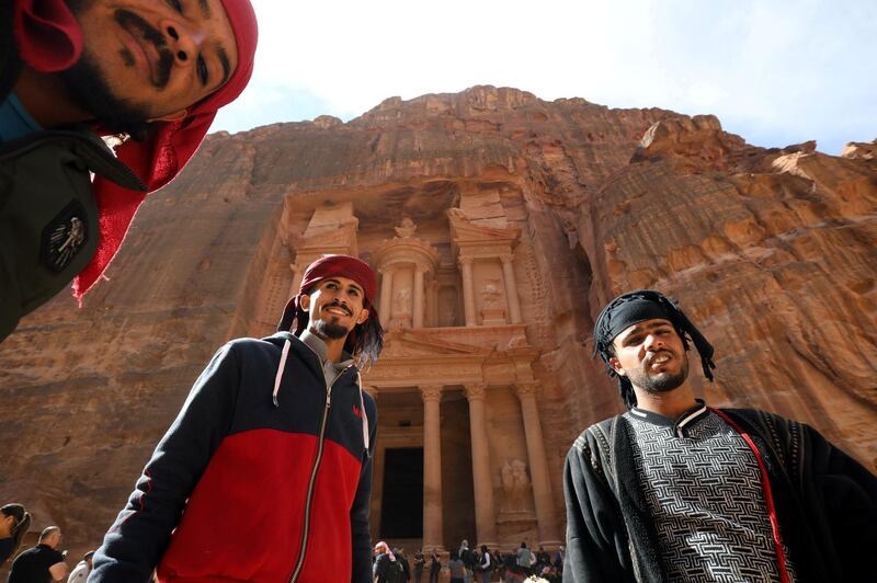 Guides wait for the tourists in front of the treasury site in the ancient city of Petra. Reuters